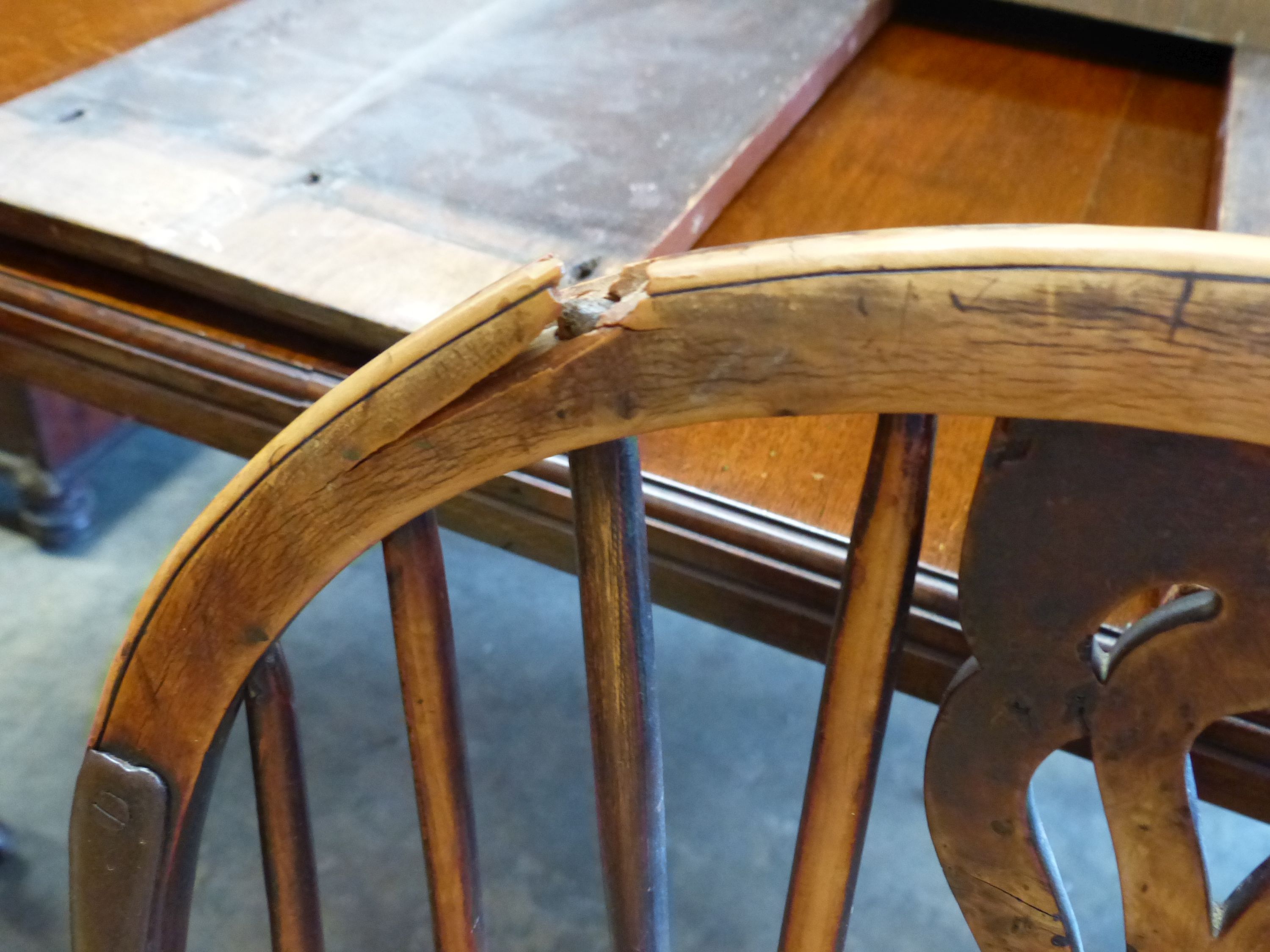 An early 19th century yew and elm Windsor kitchen elbow chair